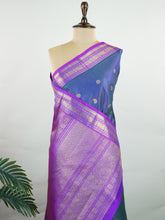 Kanchipuram Silk A bright blue saree in pure silk with pink accents, this Kanchipuram Oosikattam weave is completed with a medium border and pure zari shimmer. Traditional checks meet vibrant colours in this versatile festive drape. Handwoven with precision at Manoranjitham. #Manoranjitham #OosikattamSilk #KanjivaramTradition #ColourAndCraft #SilkWithSoul Saraswathi - Manoranjitham Weaves - Handloom Store