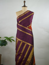 Kanchipuram Silk Pure silk in rust orange with bold horizontal stripes.
Paired with big purple gap borders.
A striking combination of colour and traditional craftsmanship. Kamini - Manoranjitham Weaves - Handloom Store