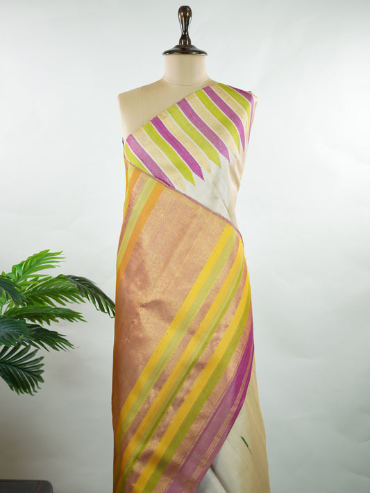 Kanchipuram Silk Soft, elegant, and timeless, this cream Kanjivaram saree is crafted in luxurious 100% pure silk for a graceful drape. The vibrant 8-kol multi-colour detailing adds festive richness, while delicate Malli Mogga buttis enhance the body with subtle floral charm. A perfect harmony of tradition and colour—ideal for weddings and special celebrations. Srishti - Manoranjitham Weaves - Handloom Store