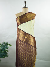 Kanchipuram Silk A delicate pista green Kanchipuram silk saree adorned with gold zari buttas, exuding subtle grace and elegance. The burgundy border lends a rich contrast, adding depth to this exquisite handloom creation. Woven from 100% pure silk, this saree is a timeless symbol of heritage and craftsmanship. Ideal for celebrations where tradition meets beauty, making every moment memorable. #ManoranjithamSilks #KanjivaramHandloom #PureSilkSaree #BridalElegance #TimelessTradition Mukhari - Manoranj