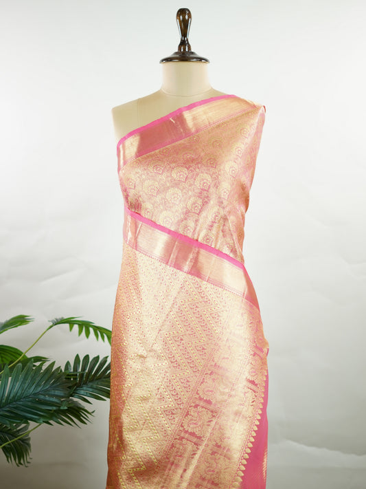 Kanchipuram Silk This Kanjivaram silk saree, adorned in Blush pink and detailed with Pure Zari weaving, reflects the grandeur of Kanchipuram. The timeless Buttis motifs enhance its bridal charm. A perfect blend of luxury and tradition, it is designed for those who appreciate fine craftsmanship. Sriranjani - Manoranjitham Weaves - Handloom Store