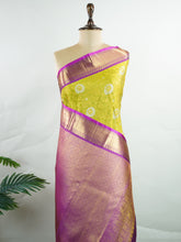 Kanchipuram Silk This Kanjivaram silk saree, adorned in Olive Green and detailed with Pure Zari weaving, reflects the grandeur of Kanchipuram. The timeless Buttis motifs enhance its bridal charm. A perfect blend of luxury and tradition, it is designed for those who appreciate fine craftsmanship. Sahana - Manoranjitham Weaves - Handloom Store