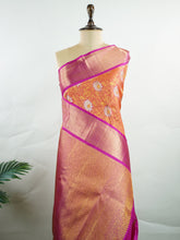 Kanchipuram Silk Handwoven by skilled artisans of Kanchipuram, this Kanjivaram saree in Orange blends traditional elegance with intricate Pure Zari zari work. A truly stunning drape for special occasions. The interplay of colors and craftsmanship makes it a treasured piece for every saree connoisseur. Suratia - Manoranjitham Weaves - Handloom Store