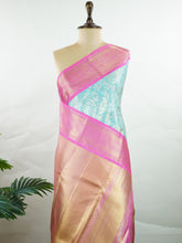 Kanchipuram Silk Handwoven by skilled artisans of Maharashtra, this 100% Pure Silk saree in Aqua Green blends traditional elegance with intricate Pure Zari zari work. A truly stunning drape for special occasions. The interplay of colors and craftsmanship makes it a treasured piece for every saree connoisseur. Joga - Manoranjitham Weaves - Handloom Store