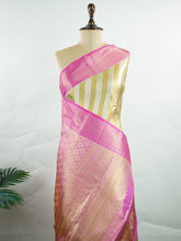 Kanchipuram Silk This royal Kanjivaram saree features a stunning diagonal pattern crafted with silver and gold Zari, making it a perfect choice for brides. The lighter pink border beautifully complements the intricate design, while the matching blouse adds to its elegance. A favorite among saree enthusiasts, this piece effortlessly combines tradition with sophistication, ensuring you radiate grace on your special day.! Gowri - Manoranjitham Weaves - Handloom Store