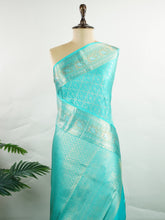 Kanchipuram Silk A pure Kanchipuram silk in tranquil cyan, adorned with gold and silver zari buttas. The self-border enhances the saree's seamless elegance, making it an exquisite choice for celebrations. Woven with precision, this handloom drape is a timeless ode to tradition. #ManoranjithamSilks #KanjivaramHandloom #PureSilkSaree #BridalElegance #TimelessTradition Charukesi - Manoranjitham Weaves - Handloom Store