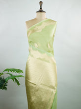 Katan An exquisite creation from Varanasi, this glass tissue saree is adorned with delicate embroidery and refined ari pita work. Its sheer texture catches the light with every fold, while the intricate detailing adds depth and artistry. A luminous drape for occasions steeped in grace and tradition. Vasanthika - Manoranjitham Weaves - Handloom Store