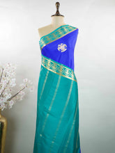 Mysore silk Rich blue Mysore silk featuring traditional checks and intricately woven Gandaberunda motifs across the body. A graceful Mysore silk saree crafted using pure handloom techniques. Its soft silk weave offers elegance with comfort. Simple styling adds timeless sophistication. Woven to reflect heritage and artistry. A beautiful saree for every occasion.brA graceful blend of heritage craftsmanship and timeless South Indian elegance. Tejomayi - Blue Pure Mysore Silk Saree | Gandaberunda Motifs - Manor