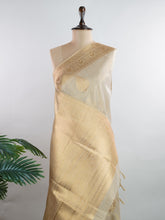 tissue This Kora Semi Tissue saree in rich gold features elegant stripes woven with fine zari. Lightweight and luminous, it captures the essence of festive finesse. Crafted in Varanasi, it drapes with ease and radiance. A timeless choice for celebrations with subtle grandeur. #KoraSemiTissue #GoldStripes #FineZari #VaranasiWeaves #ManoranjithamSarees Ahalya - Manoranjitham Weaves - Handloom Store