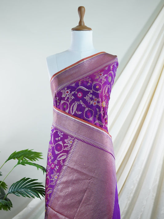 Katan An exquisite creation from Varanasi, this glass tissue saree is adorned with delicate embroidery and refined ari pita work. Its sheer texture catches the light with every fold, while the intricate detailing adds depth and artistry. A luminous drape for occasions steeped in grace and tradition. Vimalaprabha - Manoranjitham Weaves - Handloom Store