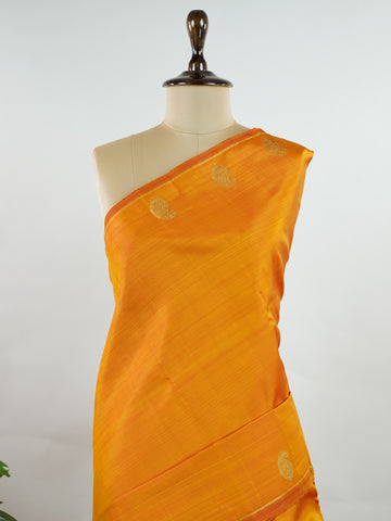 Kanchipuram Silk A bold classic in 100% pure silk, this Kanchipuram weave is a celebration of grace in its plain, glowing form. The vibrant body, paired with subtle gold zari, creates a quiet sophistication without the need for borders. Handwoven with devotion, it honours the legacy of bridal silks with contemporary elegance. An heirloom-worthy drape from Manoranjitham’s borderless Kanjivaram series. #KanchipuramSilk #Manoranjitham #PureZari #HandloomLuxury #TimelessElegance Padmakshi - Manoranjitham Weaves