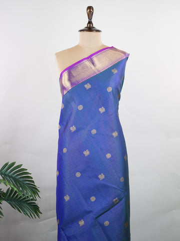 Kanchipuram Silk In a striking combination of blue and purple, this Vairavoosi Kanchipuram saree in 100% pure silk is woven with pure zari and finished with a medium border. Bold yet elegant, this drape mirrors the rhythm of traditional craft. A regal weave for those who carry confidence in colour. #Manoranjitham #VairavoosiWeave #KanjivaramSilks #HandloomStory #BoldAndTraditional Sreemaata - Pure Kanjivaram Silk Saree | Vairavoosi Weave - Manoranjitham Weaves - Handloom Store