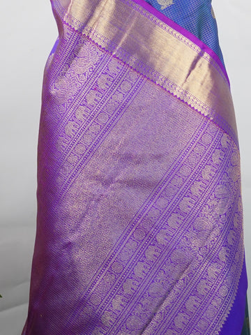 Kanchipuram Silk In a striking combination of blue and purple, this Vairavoosi Kanchipuram saree in 100% pure silk is woven with pure zari and finished with a medium border. Bold yet elegant, this drape mirrors the rhythm of traditional craft. A regal weave for those who carry confidence in colour. #Manoranjitham #VairavoosiWeave #KanjivaramSilks #HandloomStory #BoldAndTraditional Sreemaata - Pure Kanjivaram Silk Saree | Vairavoosi Weave - Manoranjitham Weaves - Handloom Store