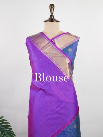 Kanchipuram Silk In a striking combination of blue and purple, this Vairavoosi Kanchipuram saree in 100% pure silk is woven with pure zari and finished with a medium border. Bold yet elegant, this drape mirrors the rhythm of traditional craft. A regal weave for those who carry confidence in colour. #Manoranjitham #VairavoosiWeave #KanjivaramSilks #HandloomStory #BoldAndTraditional Sreemaata - Pure Kanjivaram Silk Saree | Vairavoosi Weave - Manoranjitham Weaves - Handloom Store