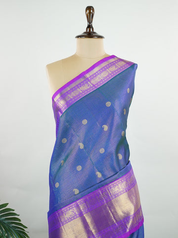 Kanchipuram Silk A bright blue saree in pure silk with pink accents, this Kanchipuram Oosikattam weave is completed with a medium border and pure zari shimmer. Traditional checks meet vibrant colours in this versatile festive drape. Handwoven with precision at Manoranjitham. #Manoranjitham #OosikattamSilk #KanjivaramTradition #ColourAndCraft #SilkWithSoul Saraswathi - Manoranjitham Weaves - Handloom Store