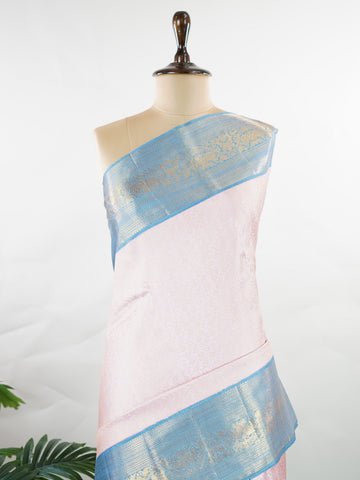 Kanchipuram Silk Beautiful bridal Kanjivaram saree featuring a charming Baby Pink body, beautifully contrasted with a graceful Pastel Blue border, pallu, and matching blouse. The delicate blend of Baby Pink and Pastel Blue creates a dreamy and elegant bridal palette with timeless appeal. Expertly woven with exquisite Kanjivaram craftsmanship, the saree radiates sophistication, grace, and refined luxury. A perfect choice for weddings and grand celebrations, this enchanting drape captures the essence of beaut