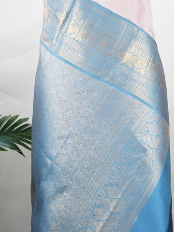 Kanchipuram Silk Beautiful bridal Kanjivaram saree featuring a charming Baby Pink body, beautifully contrasted with a graceful Pastel Blue border, pallu, and matching blouse. The delicate blend of Baby Pink and Pastel Blue creates a dreamy and elegant bridal palette with timeless appeal. Expertly woven with exquisite Kanjivaram craftsmanship, the saree radiates sophistication, grace, and refined luxury. A perfect choice for weddings and grand celebrations, this enchanting drape captures the essence of beaut