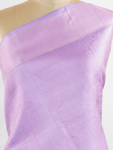 Kanchipuram Silk A rare lavender silk drape, adorned with traditional kattam checks and delicate buttas. The silver-gold zari glistens, casting a regal glow on this soft pastel beauty. Perfect for evening weddings where elegance speaks in hushed tones. An heirloom piece, woven with precision in the looms of Kanchipuram. #LavenderKanjivaram #KattamChecks #PureZari #HeritageSilks Shubhapantuvarali - Lavender Pure Kanjivaram Silk Saree | Woven Buttas - Manoranjitham Weaves - Handloom Store