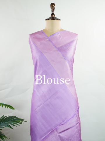 Kanchipuram Silk A rare lavender silk drape, adorned with traditional kattam checks and delicate buttas. The silver-gold zari glistens, casting a regal glow on this soft pastel beauty. Perfect for evening weddings where elegance speaks in hushed tones. An heirloom piece, woven with precision in the looms of Kanchipuram. #LavenderKanjivaram #KattamChecks #PureZari #HeritageSilks Shubhapantuvarali - Lavender Pure Kanjivaram Silk Saree | Woven Buttas - Manoranjitham Weaves - Handloom Store