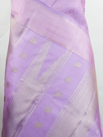 Kanchipuram Silk A rare lavender silk drape, adorned with traditional kattam checks and delicate buttas. The silver-gold zari glistens, casting a regal glow on this soft pastel beauty. Perfect for evening weddings where elegance speaks in hushed tones. An heirloom piece, woven with precision in the looms of Kanchipuram. #LavenderKanjivaram #KattamChecks #PureZari #HeritageSilks Shubhapantuvarali - Lavender Pure Kanjivaram Silk Saree | Woven Buttas - Manoranjitham Weaves - Handloom Store