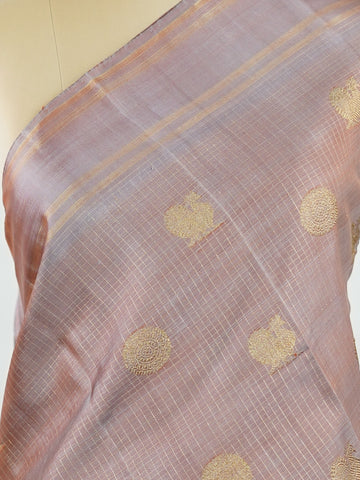 Kanchipuram Silk Earthy elegance meets intricate artistry in this light brown Kanjivaram. Oosikattam patterns and tiny buttas add texture to the soft sheen of silk. Ideal for cultural events and sacred celebrations. A classic drape for women who value understated heritage. #LightBrownSilk #OosikattamWeave #PureZari #HandloomBeauty Kedaragaula - Manoranjitham Weaves - Handloom Store