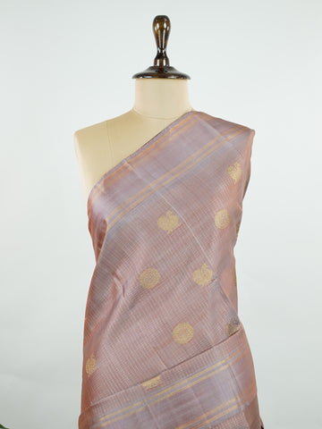 Kanchipuram Silk Earthy elegance meets intricate artistry in this light brown Kanjivaram. Oosikattam patterns and tiny buttas add texture to the soft sheen of silk. Ideal for cultural events and sacred celebrations. A classic drape for women who value understated heritage. #LightBrownSilk #OosikattamWeave #PureZari #HandloomBeauty Kedaragaula - Manoranjitham Weaves - Handloom Store