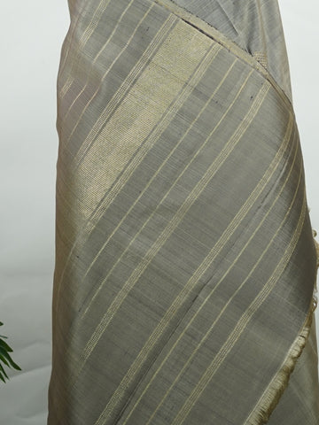 Kanchipuram Silk Soft grey silk enriched with intricate kolam buttas in pure zari. The muted tones radiate understated elegance for refined gatherings. Lightweight yet luxurious in drape. A subtle masterpiece for quiet sophistication. #GreySilkSaree #KolamButta #PureZariKanjivaram #MinimalLuxury Hemavati - Manoranjitham Weaves - Handloom Store