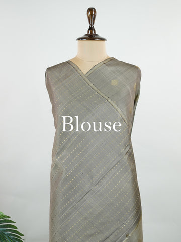 Kanchipuram Silk Soft grey silk enriched with intricate kolam buttas in pure zari. The muted tones radiate understated elegance for refined gatherings. Lightweight yet luxurious in drape. A subtle masterpiece for quiet sophistication. #GreySilkSaree #KolamButta #PureZariKanjivaram #MinimalLuxury Hemavati - Manoranjitham Weaves - Handloom Store