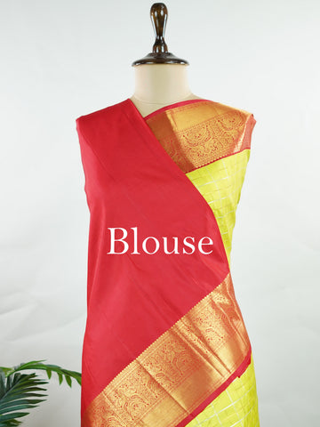 Kanchipuram Silk Beautiful traditional Kanjivaram saree featuring a vibrant Leaf Green body adorned with exquisite gold and silver checks, creating a rich and radiant appearance. The striking Red border is embellished with majestic Annapakshi motifs, adding a touch of heritage and timeless elegance. An intricately woven pallu with classic diamond motifs enhances the grandeur and sophistication of the drape. Paired with a plain Red blouse, this masterpiece is perfect for weddings, festive occasions, and trad