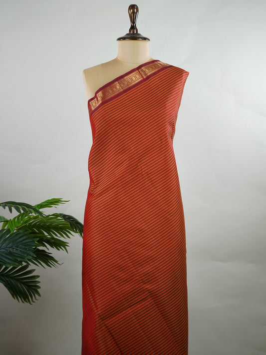 Kanchipuram Silk Multicolour handloom Kanjivaram with vibrant orange, green and maroon stripes, exuding vintage charm.
Paired with a delicate maroon border, this saree brings timeless elegance and a refined festive look. Kamakshi - Manoranjitham Weaves - Handloom Store