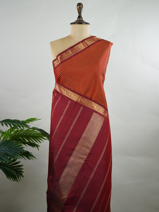 Kanchipuram Silk Multicolour handloom Kanjivaram with vibrant orange, green and maroon stripes, exuding vintage charm.
Paired with a delicate maroon border, this saree brings timeless elegance and a refined festive look. Kamakshi - Manoranjitham Weaves - Handloom Store