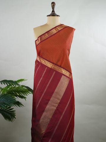Kanchipuram Silk Multicolour handloom Kanjivaram with vibrant orange, green and maroon stripes, exuding vintage charm.
Paired with a delicate maroon border, this saree brings timeless elegance and a refined festive look. Kamakshi - Manoranjitham Weaves - Handloom Store
