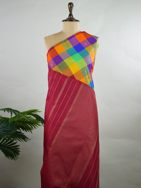 Kanchipuram Silk Borderless handloom Kanjivaram with multicolour checks and delicate buttis throughout.
Complemented by a rich maroon pallu and blouse in pure zari, giving it a timeless vintage elegance. Kamakalatmika - Manoranjitham Weaves - Handloom Store