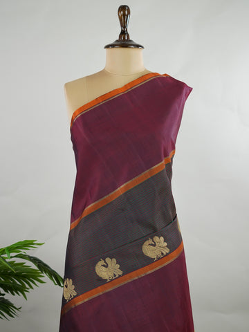 Kanchipuram Silk Green and maroon multi-stripe handloom Kanjivaram, with dancing peacock motifs above the border and a clean big-gap border design.
The maroon pallu features the classic laksha butti concept, giving it a vintage, timeless charm. Manonmani - Manoranjitham Weaves - Handloom Store
