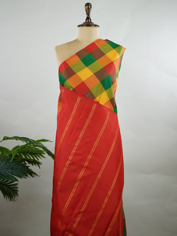 Kanchipuram Silk Borderless handloom Kanjivaram with multi-coloured checks, simple and elegant.
Complemented by a rich red pallu and blouse, perfect for a classic, timeless look. Hamsa Vahini - Manoranjitham Weaves - Handloom Store
