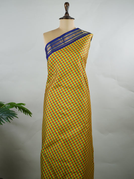 Kanchipuram Silk Pure silk woven with fine multi small checks.
Accented with a traditional blue korvai (kuttu) border.
Finished with a blue pallu and matching blouse for timeless elegance. Shyama - Manoranjitham Weaves - Handloom Store