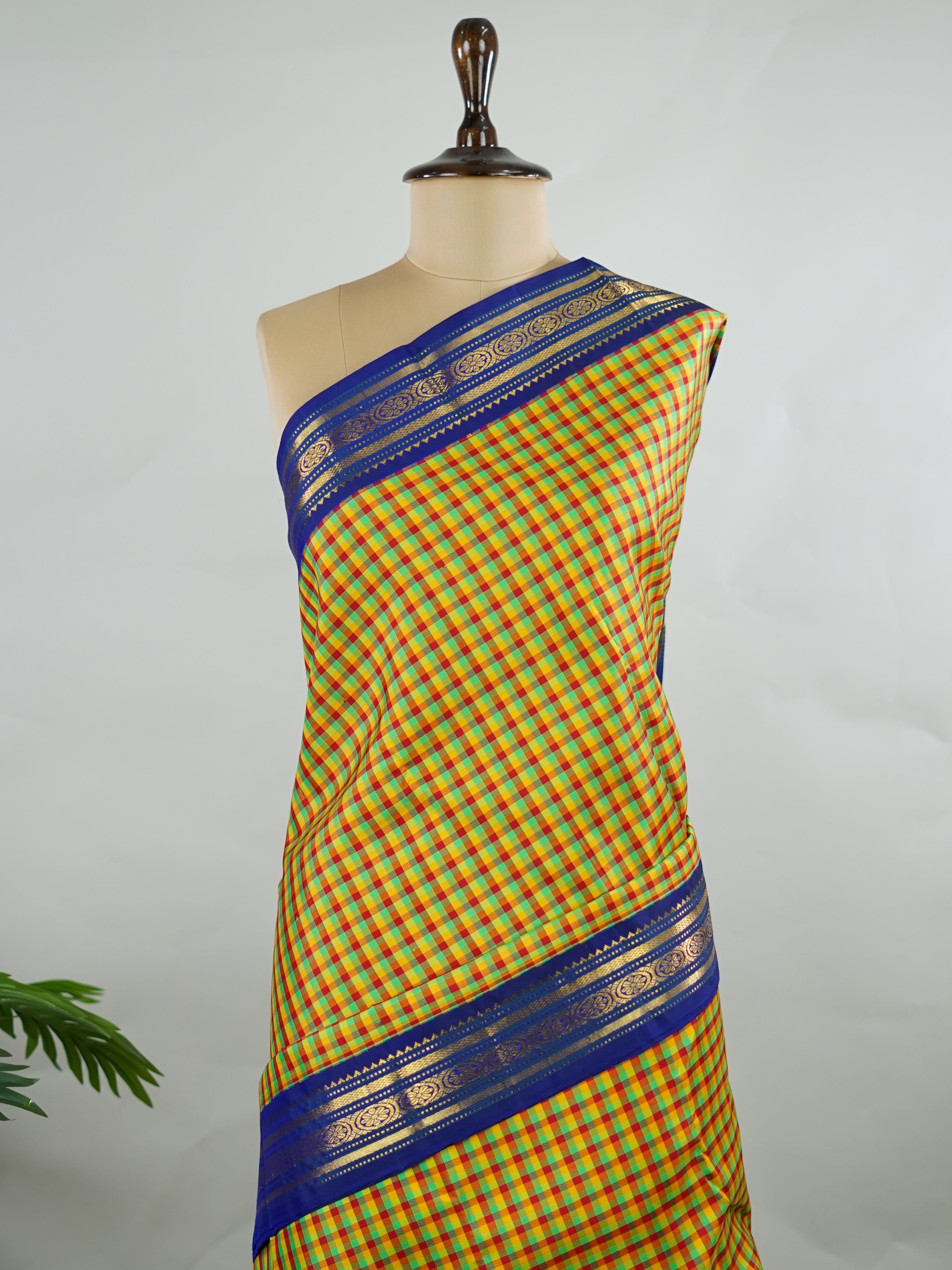 Kanchipuram Silk Pure silk woven with fine multi small checks.br
Accented with a traditional blue korvai (kuttu) border.br
Finished with a blue pallu and matching blouse for timeless elegance. Shyama - Pure Kanjivaram Silk Saree | Korvai Border - Manoranjitham Weaves - Handloom Store