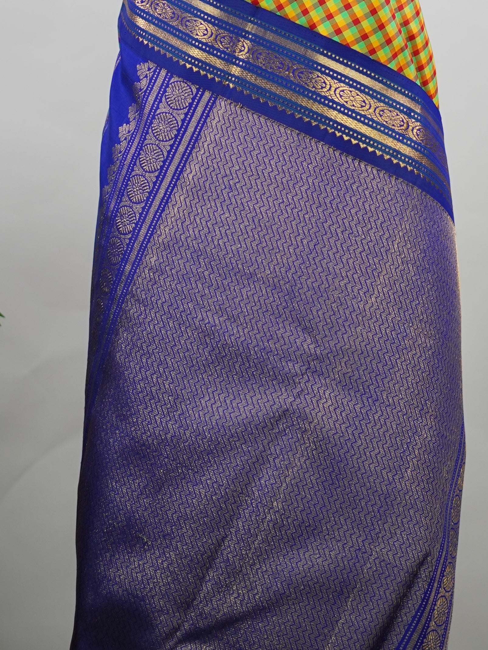 Kanchipuram Silk Pure silk woven with fine multi small checks.br
Accented with a traditional blue korvai (kuttu) border.br
Finished with a blue pallu and matching blouse for timeless elegance. Shyama - Pure Kanjivaram Silk Saree | Korvai Border - Manoranjitham Weaves - Handloom Store