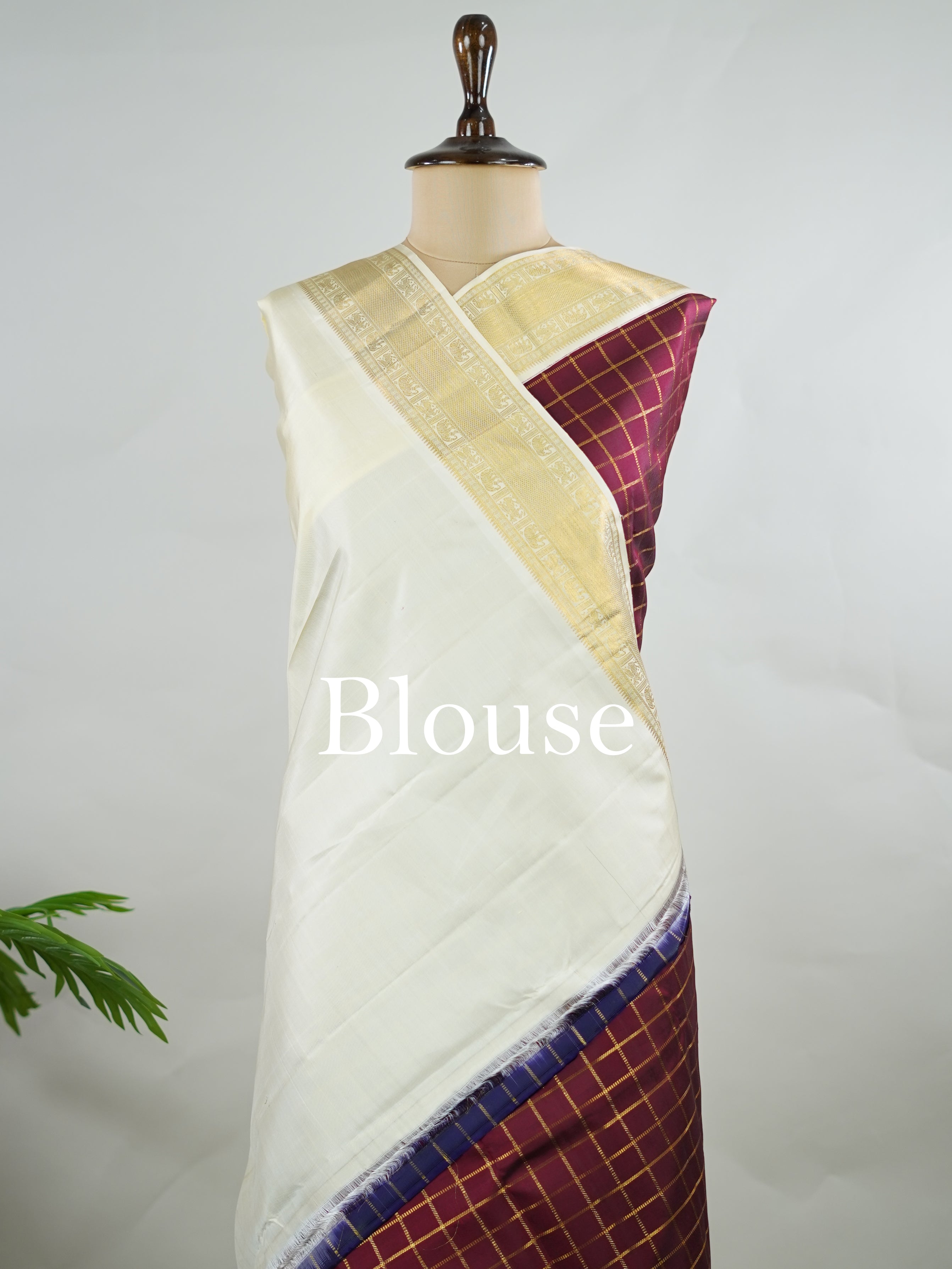 Kanchipuram Silk Pure silk woven in deep maroon checks.
Paired with a rich cream pallu and matching border.
Completed with a plain blouse for understated elegance. Kripa - Manoranjitham Weaves - Handloom Store