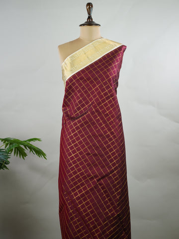 Kanchipuram Silk Pure silk woven in deep maroon checks.
Paired with a rich cream pallu and matching border.
Completed with a plain blouse for understated elegance. Kripa - Manoranjitham Weaves - Handloom Store