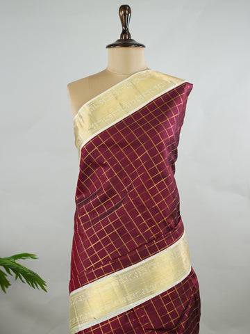 Kanchipuram Silk Pure silk woven in deep maroon checks.
Paired with a rich cream pallu and matching border.
Completed with a plain blouse for understated elegance. Kripa - Manoranjitham Weaves - Handloom Store
