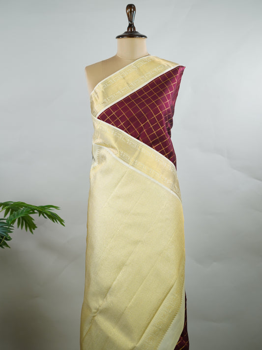 Kanchipuram Silk Pure silk woven in deep maroon checks.
Paired with a rich cream pallu and matching border.
Completed with a plain blouse for understated elegance. Kripa - Manoranjitham Weaves - Handloom Store