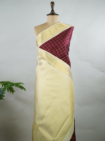 Kanchipuram Silk Pure silk woven in deep maroon checks.
Paired with a rich cream pallu and matching border.
Completed with a plain blouse for understated elegance. Kripa - Manoranjitham Weaves - Handloom Store