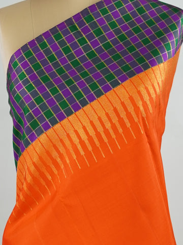 Kanchipuram Silk Pure silk in vibrant orange.
Paired with temple borders and multi-colour checked borders.
Blouse and pallu echo the same border design for a harmonious, elegant look. Kamini - Manoranjitham Weaves - Handloom Store