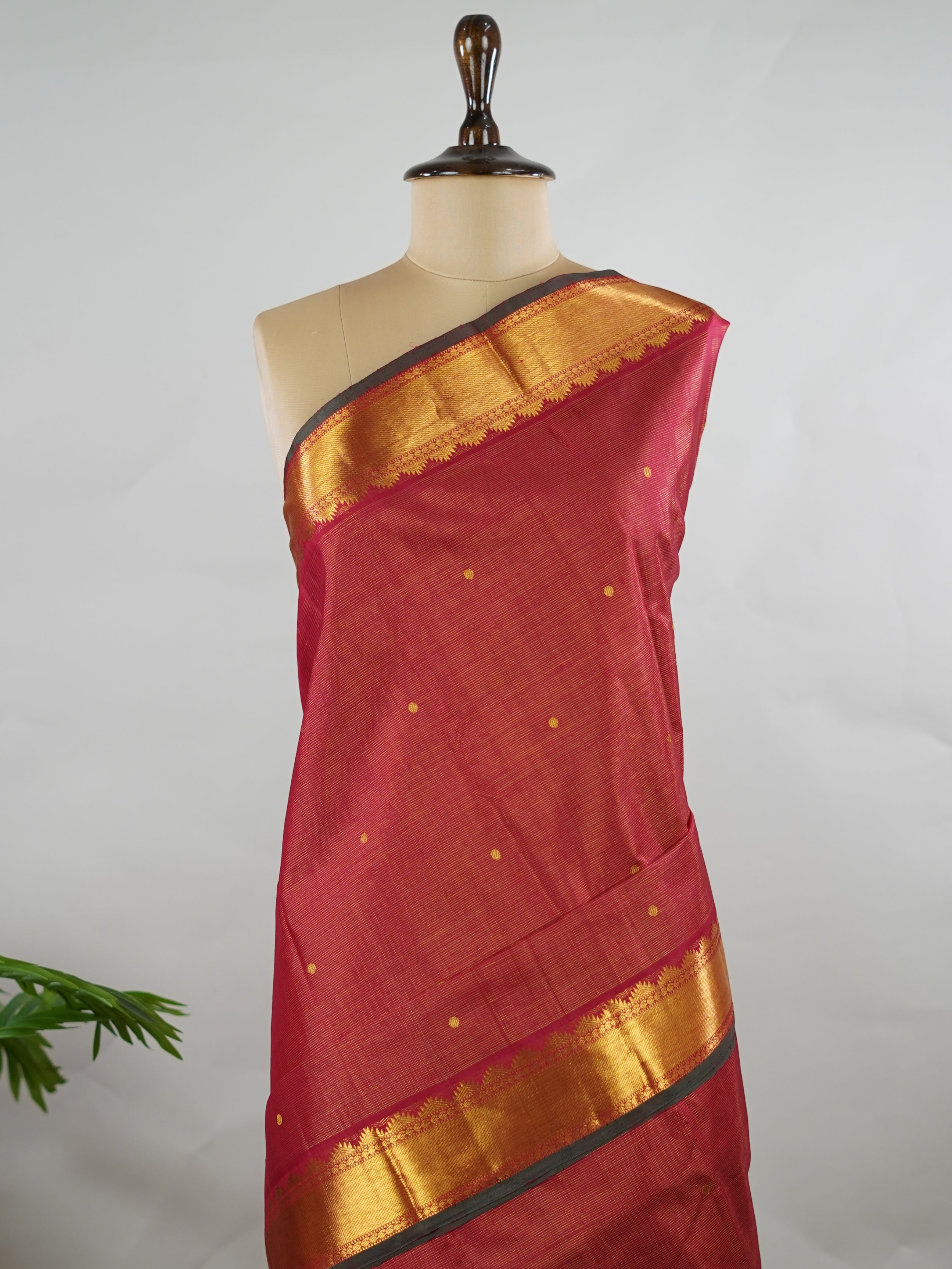 Kanchipuram Silk Pure silk in deep maroon Vairavoosi weave with delicate buttas on the body.
Paired with a rich pallu and a matching Vairavoosi blouse.
Accented with a traditional kaddi border for timeless elegance. Shobha - Manoranjitham Weaves - Handloom Store