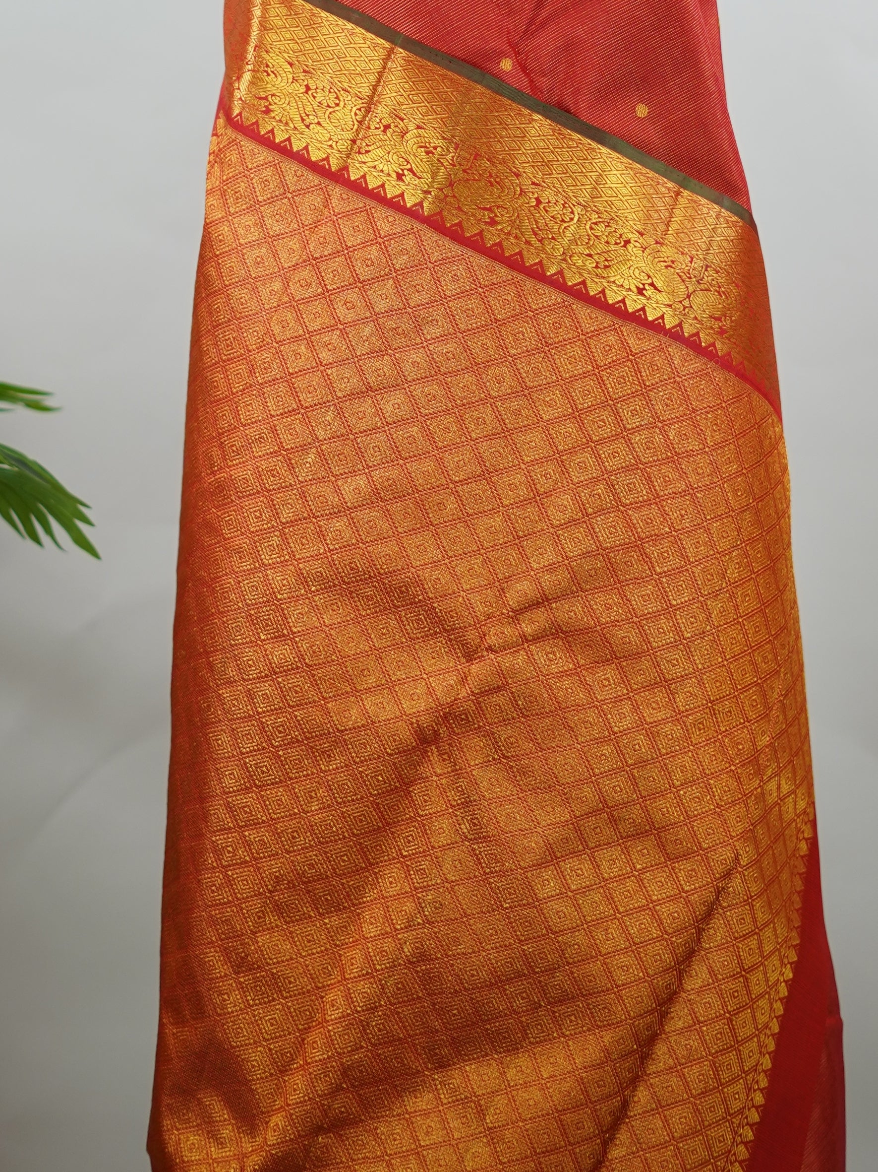 Kanchipuram Silk Pure silk in vibrant orange Vairavoosi weave with delicate buttas on the body.
Paired with a rich pallu and a matching Vairavoosi blouse.
Accented with a traditional kaddi border for timeless elegance. Shakti - Manoranjitham Weaves - Handloom Store