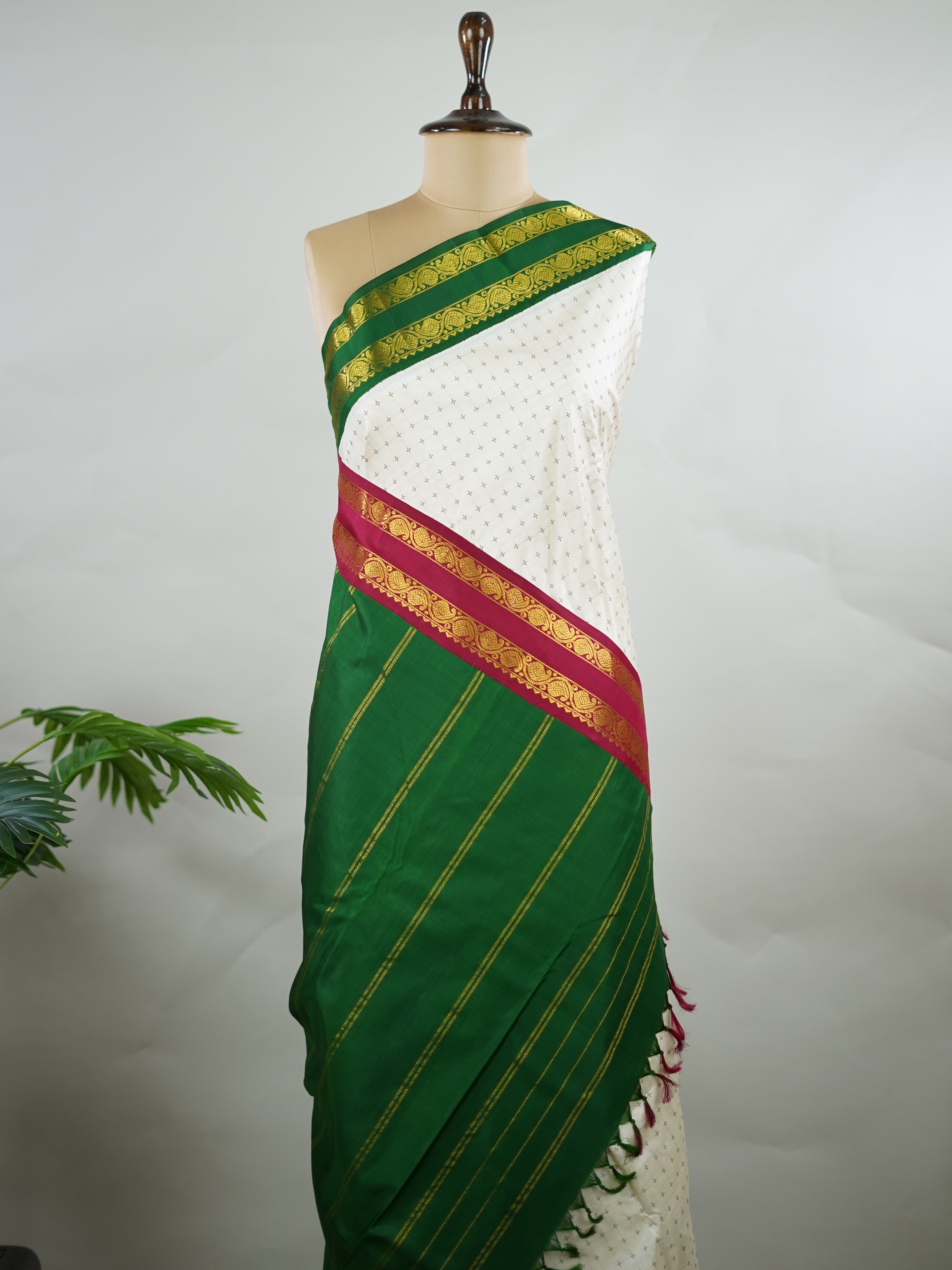 Kanchipuram Silk Pure silk with white Laksha Deepam style buttas on the body.
Paired with dual pallu in green and maroon, and a maroon blouse.
Accented with a classic Ganga-Jamuna border for timeless elegance. Sivamayi - Manoranjitham Weaves - Handloom Store