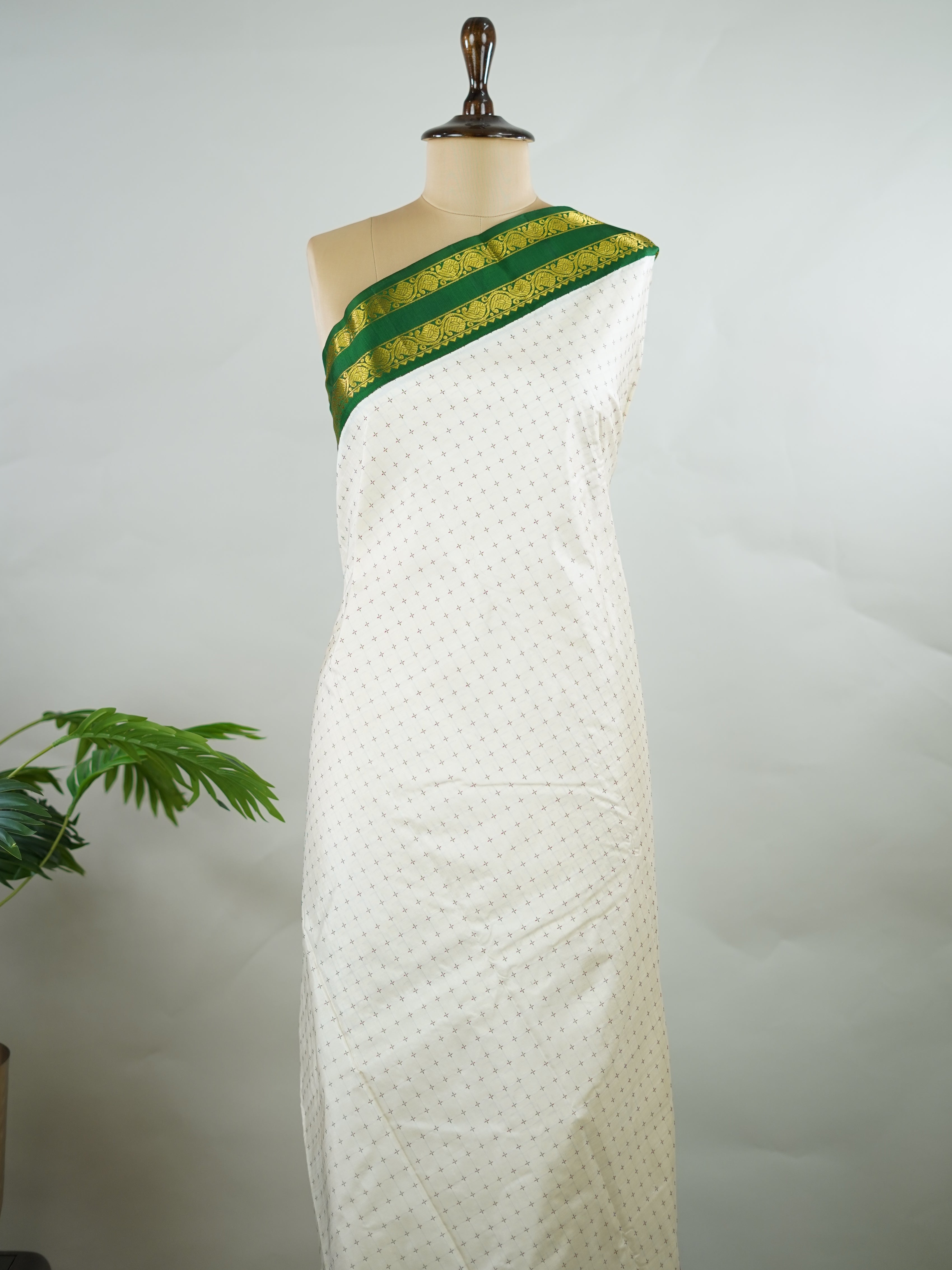 Kanchipuram Silk Pure silk with white Laksha Deepam style buttas on the body.
Paired with dual pallu in green and maroon, and a maroon blouse.
Accented with a classic Ganga-Jamuna border for timeless elegance. Sivamayi - Manoranjitham Weaves - Handloom Store
