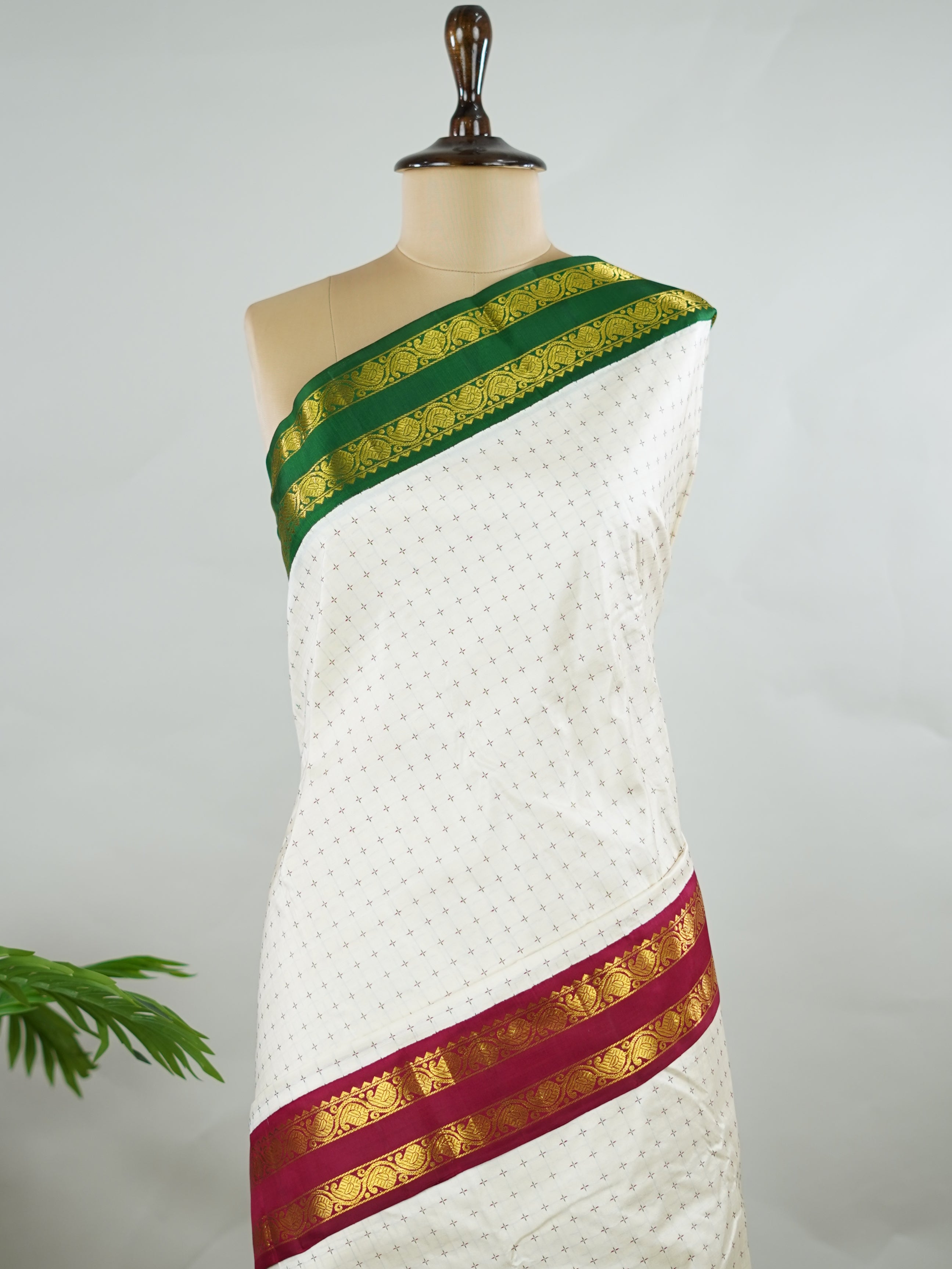 Kanchipuram Silk Pure silk with white Laksha Deepam style buttas on the body.
Paired with dual pallu in green and maroon, and a maroon blouse.
Accented with a classic Ganga-Jamuna border for timeless elegance. Sivamayi - Manoranjitham Weaves - Handloom Store