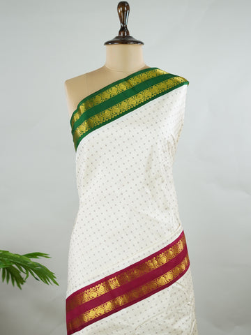 Kanchipuram Silk Pure silk with white Laksha Deepam style buttas on the body.
Paired with dual pallu in green and maroon, and a maroon blouse.
Accented with a classic Ganga-Jamuna border for timeless elegance. Sivamayi - Manoranjitham Weaves - Handloom Store